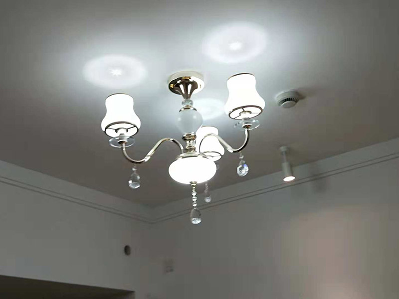 吊燈安裝：一、確定位置  吊燈位置確定之后，還要注意檢測該位置的承重力，畢竟一盞吊燈的重量還是蠻重的，尤其是客餐廳吊燈又大又重，倘若頂面承重力不夠，時間長了會有脫落的危險。所以吊燈安裝位置應(yīng)是實心磚石頂面或墻面，不宜是輕質(zhì)木質(zhì)頂面。 步驟二、拆吊燈面罩  吊燈面罩會有旋轉(zhuǎn)式和卡扣式兩種固定方式，大家拆卸時要小心謹(jǐn)慎，不要弄壞吊燈了。面罩和燈管都要取下來，以免安裝的過程中碰碎燈管。 三、安裝底座  將吊燈底座對著頂面或墻面的安裝位置，找到孔位并標(biāo)記出來，然后放下底座，使用與孔位規(guī)格相同的電鉆來打孔，天花板孔位一般是在6毫米，打孔完畢后就可以安裝膨脹螺栓了，這是固定吊燈底座用的，不過要注意孔的深度，要把膨脹螺絲塞入孔內(nèi)，使用錘子把它敲進(jìn)去，之后將底座與膨脹螺栓擰緊、固定，要與預(yù)先確定的安裝位置相同，不能有偏移的情況。 四、連接燈線   吊燈底座固定后，就可以連接燈線與電源線了，不過要注意連接的兩個線頭要接觸良好，需用黑膠布包裹好，并注意保持間距，盡量不把兩個連接頭放在一塊金屬片下，防止產(chǎn)生短路帶來危險。連接好燈線與電源線后就可以安裝燈管，這時可通電檢查，看看能否正常使用，如不正常要檢查線路，若一切OK，那么就要關(guān)閉電源再繼續(xù)吊燈后續(xù)安裝。