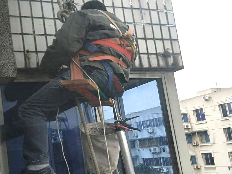 外墻高空維修：1、目前外墻粉刷主要有兩種方式：吊板方式和吊籃方式。 2、吊板方式是用吊繩、吊板將人吊到工作位置進(jìn)行清洗。一般的大樓都可以用這種方式進(jìn)行清洗，但是這種方式的操作必須使安全措施到位，否則危險(xiǎn)性很大，造成傷亡事故的都是因安全措施不到位造成的。 3、對(duì)于無(wú)承載能力、疏松、起皮的舊涂層，應(yīng)連同膩?zhàn)訌氐诅P除，洗凈且干燥后再用膩?zhàn)诱移健?duì)于輕度粉化但牢固的舊涂層打磨平整后用封底漆底涂即可。嚴(yán)重粉化的舊涂層應(yīng)事先徹底清洗，舊的油性涂料應(yīng)完全去除。