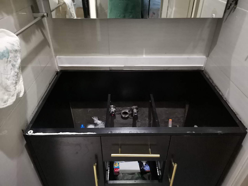 浴室柜安裝：在標(biāo)注好的位置，用氣鉆打孔先安裝主柜；再安裝洗臉盆，用玻璃膠固定好；再安裝水龍頭，接著就是下水器；安裝鏡子，還有置物架；完成。