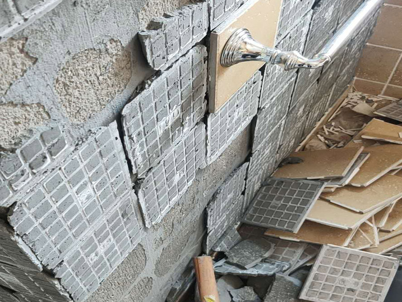 瓷磚空鼓脫落鋪貼:將挑選好的瓷磚浸泡在水盆里，浸泡時間按瓷磚的密度而定，以水盆里不出水泡為好，說明瓷磚內(nèi)部已無空氣。瓷磚泡好后，將瓷磚從水盆里拿出來，瀝瀝水，瓷磚有水較滑，動作要輕巧小心，以免瓷磚滑落摔破。晾干后，瓷磚鋪貼平整，也要求墻壁本身要平整，用直尺在毛坯房墻面找平。將801膠水與水按1：5的比例調(diào)配，膠水取代傳統(tǒng)的黃沙讓泥漿更有粘性。墻面如果有不平整的地方，用鏟刀修理平整，再用直尺檢測全部平整才合格。在墻壁上涂一層防水涂料，以防止衛(wèi)浴間的水汽滲進(jìn)墻壁。這個步驟很重要，一定不可省略。